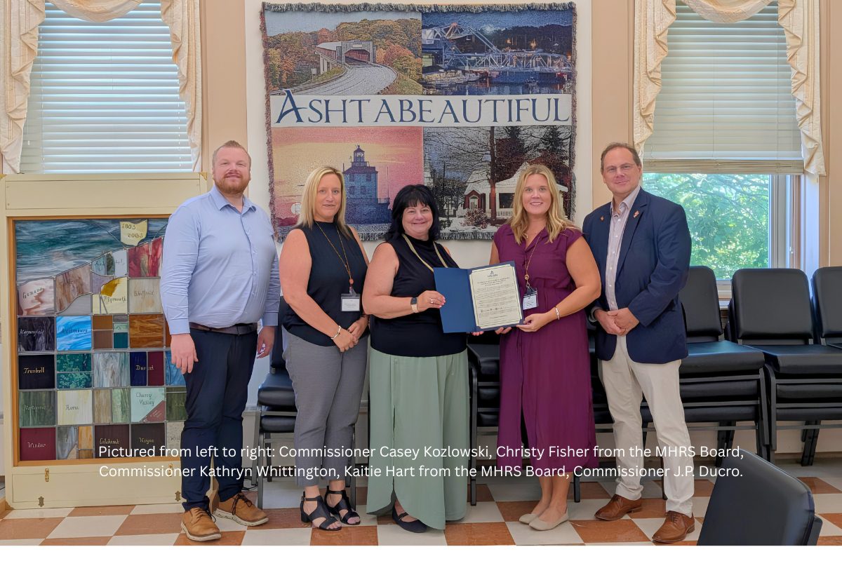 Commissioners and MHRS staff posing with a proclamation